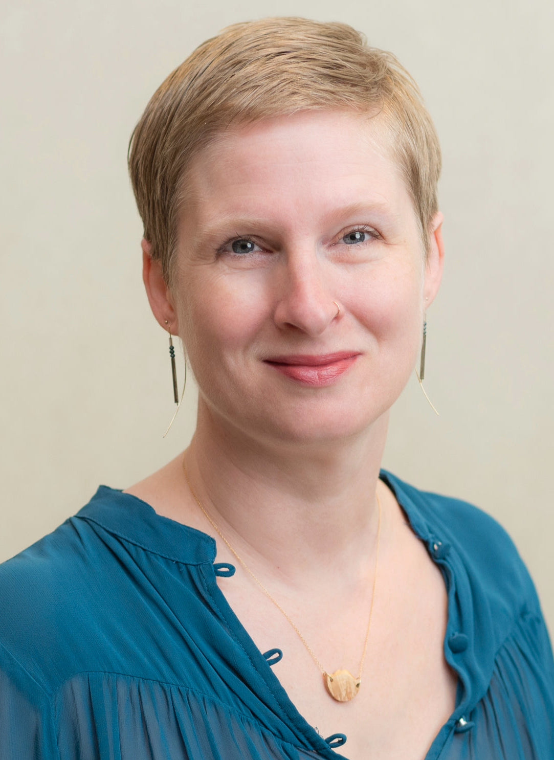 Woman wearing a blue top with a plain background