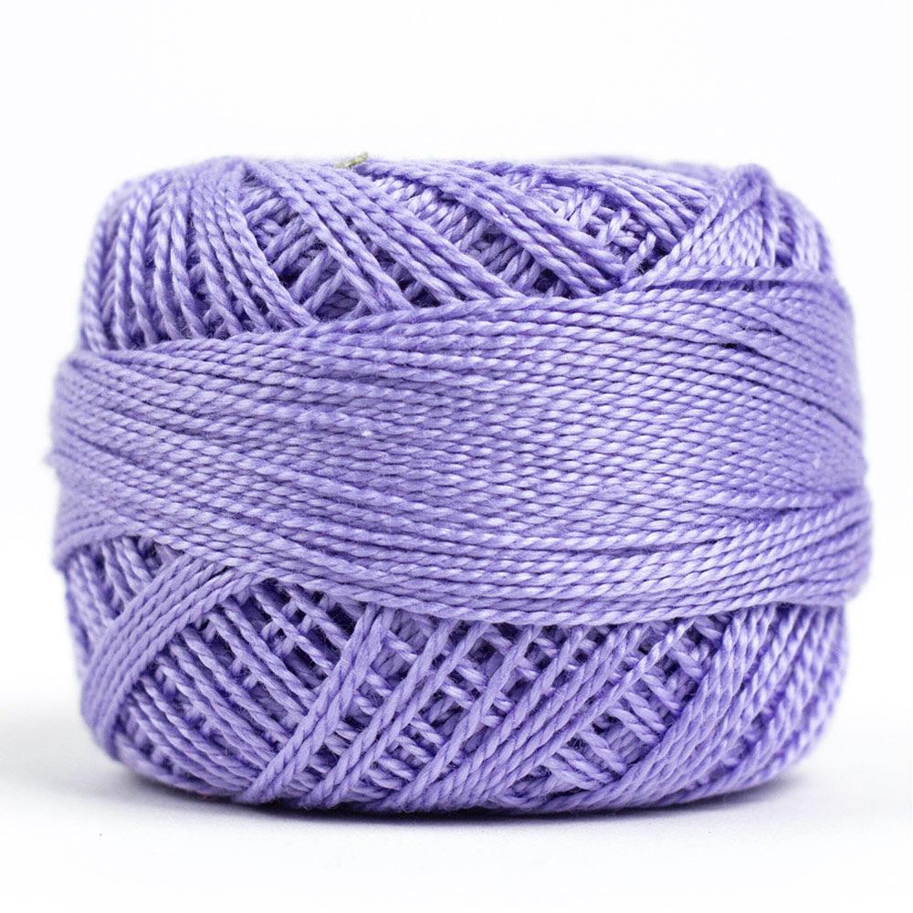 Side view of Perle cotton ball on white background to show color
