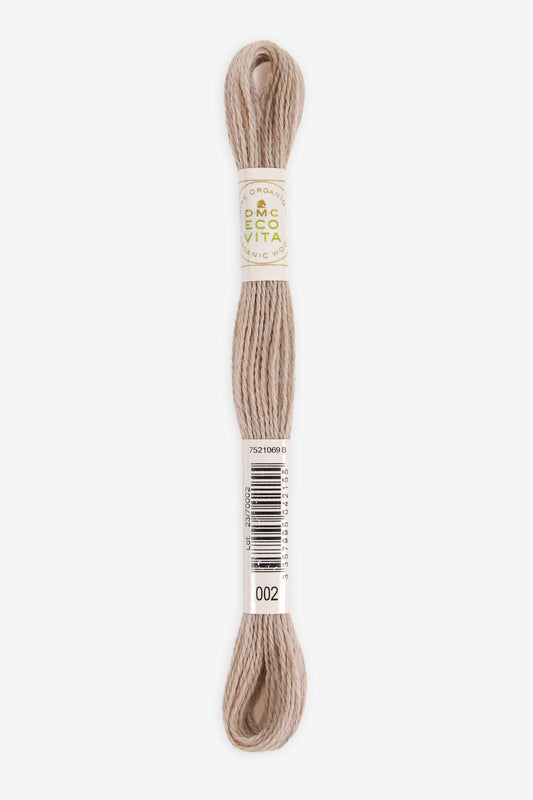 Single skein of Eco Vita Crewel Wool thread from DMC in color #002 against a white background