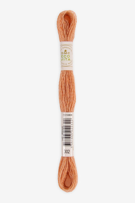 Single skein of Eco Vita Crewel Wool thread from DMC in color #302 against a white background