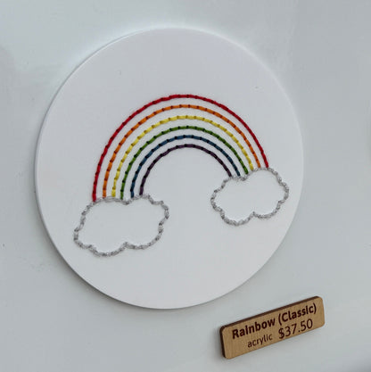 Stitch disk with rainbow adhered to a metal base for market display