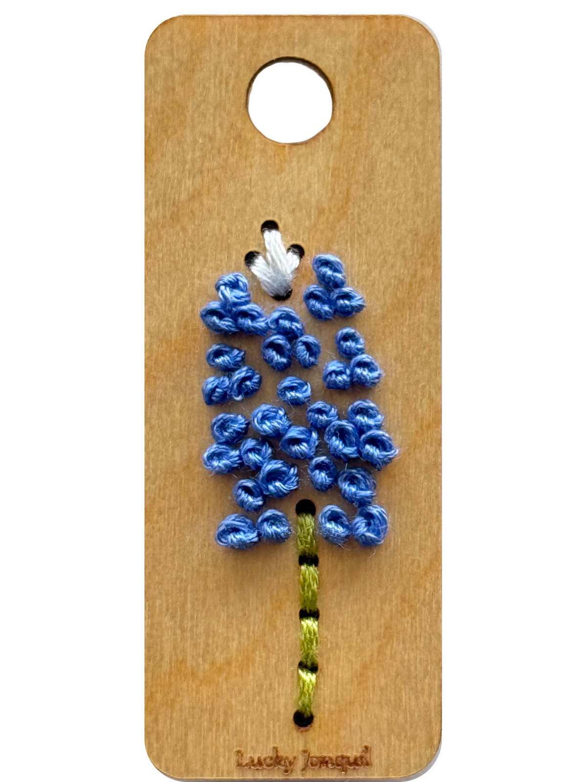 Bluebonnet sprig embroidered on a wooden rectangular base against a white background 